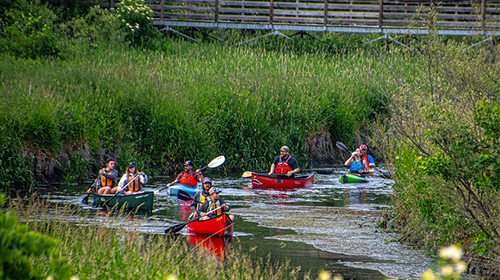 People paddling down a river