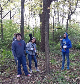 high school teens posing with brush clearing tools