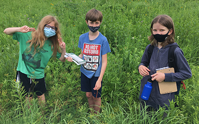 Students in a prairie holding clipboards