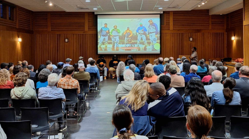 People in a room watching a film